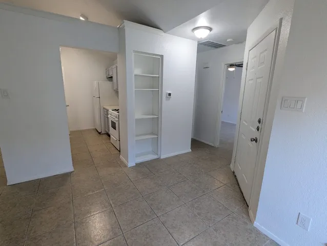 an empty room with a bathroom and a sink