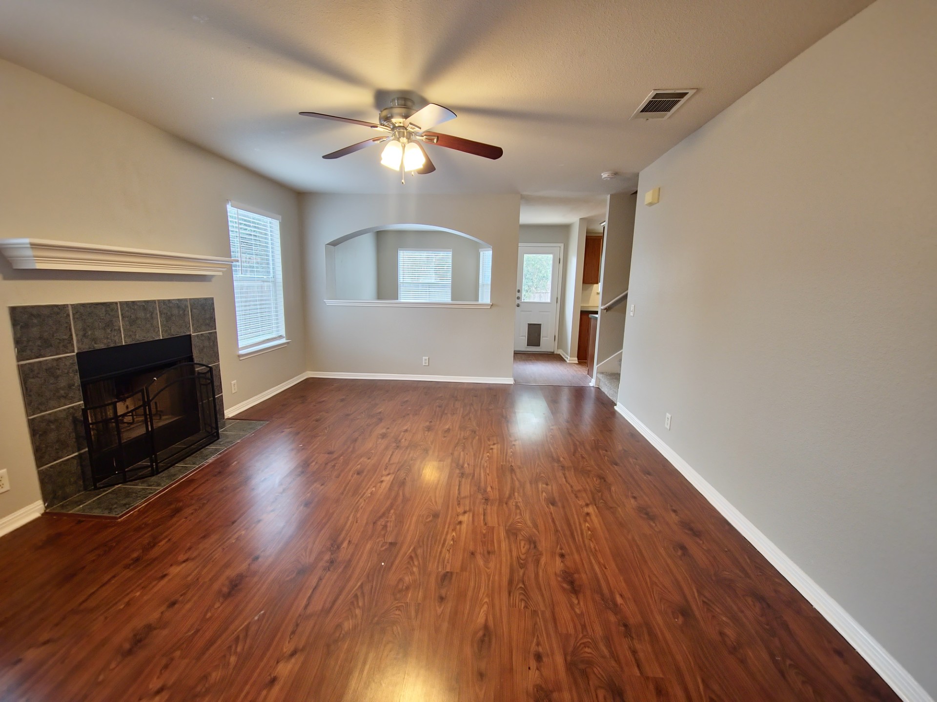 107 Orange Tree Lane Georgetown, TX 78626 - Photo 3 of 16 A welcoming living space features a tiled fireplace and rich hardwood style flooring, ready for comfortable gatherings.