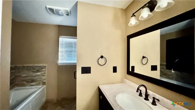 a bathroom with a sink and a mirror