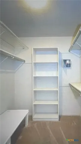 a view of a hallway with wooden floor and closet