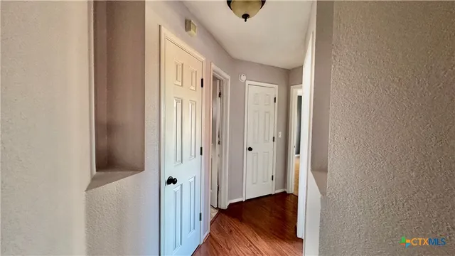 a view of hallway with wooden floor