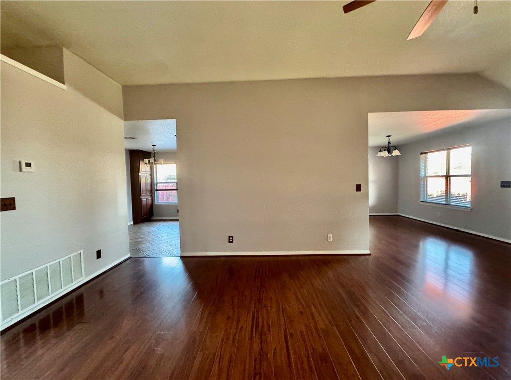 5502 Golden Drive Killeen, TX 76542 - Photo 6 of 32 an empty room with wooden floor and windows