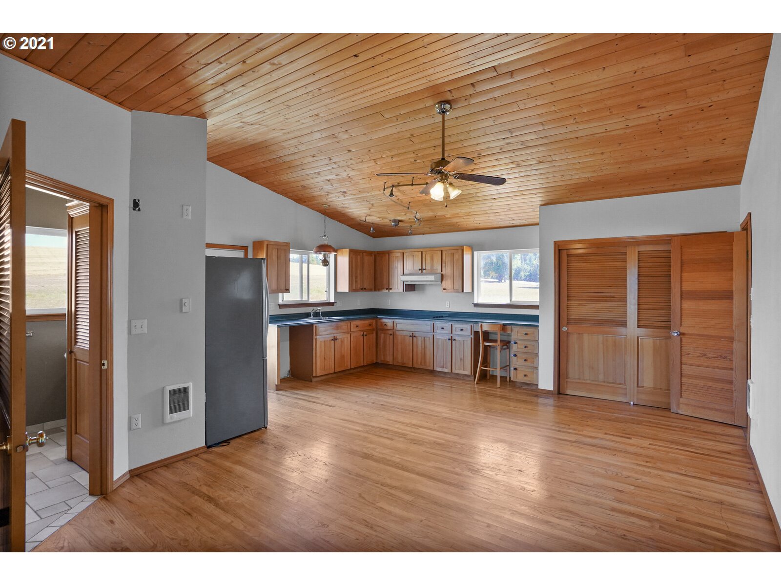 9310 Harmony Road Sheridan, OR 97378 - Photo 15 of 32 a view of an empty room with wooden floor and a window