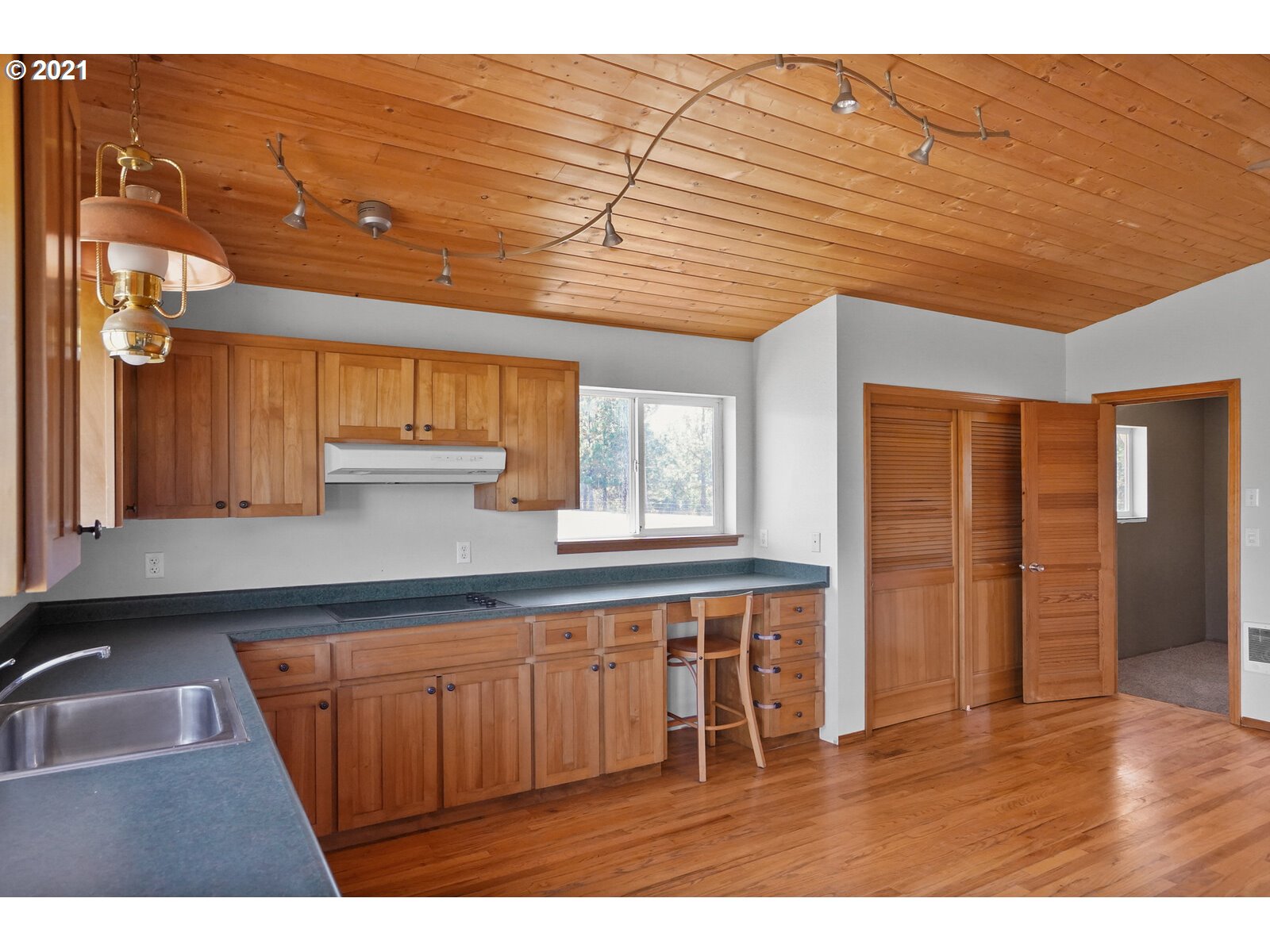 9310 Harmony Road Sheridan, OR 97378 - Photo 16 of 32 a kitchen with stainless steel appliances granite countertop a sink and wooden cabinets