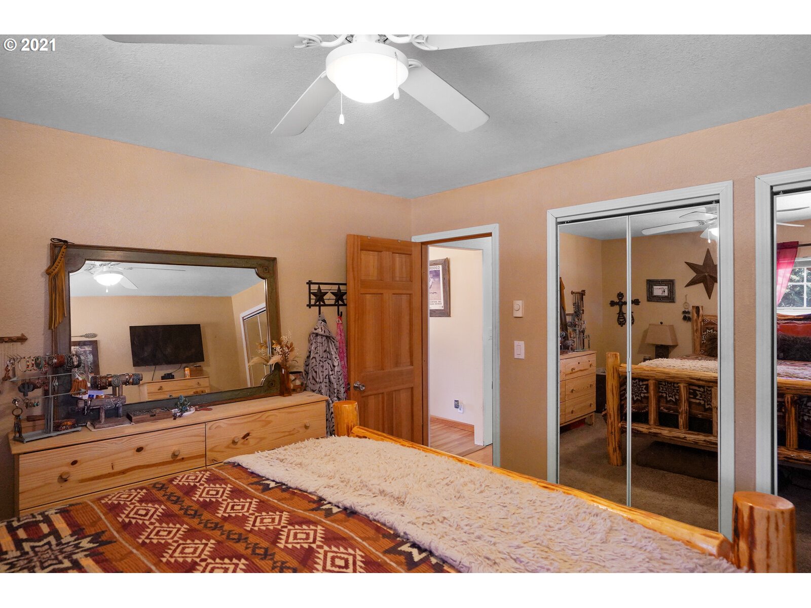 9310 Harmony Road Sheridan, OR 97378 - Photo 21 of 32 a room with a bed and a mirror on dresser