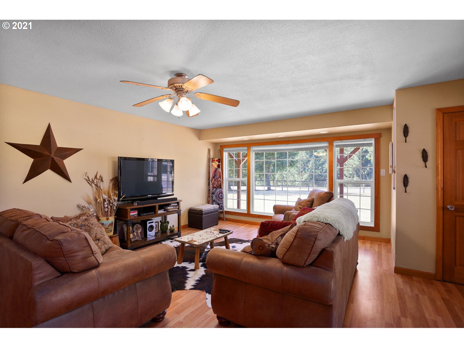 9310 Harmony Road Sheridan, OR 97378 - Photo 5 of 32 a living room with furniture a flat screen tv and a large window