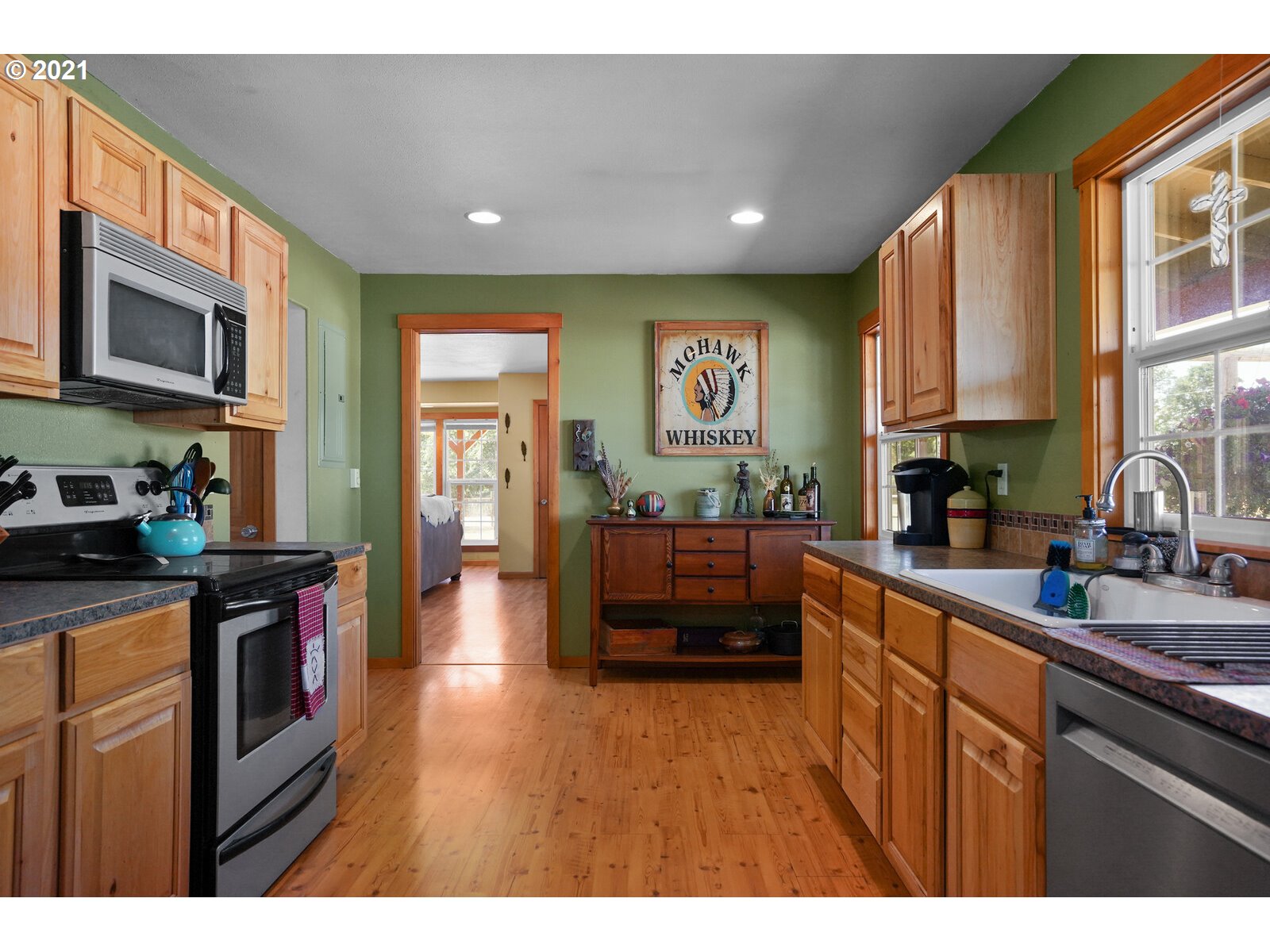 9310 Harmony Road Sheridan, OR 97378 - Photo 7 of 32 a kitchen with stainless steel appliances granite countertop a stove a sink dishwasher and a microwave with wooden floor
