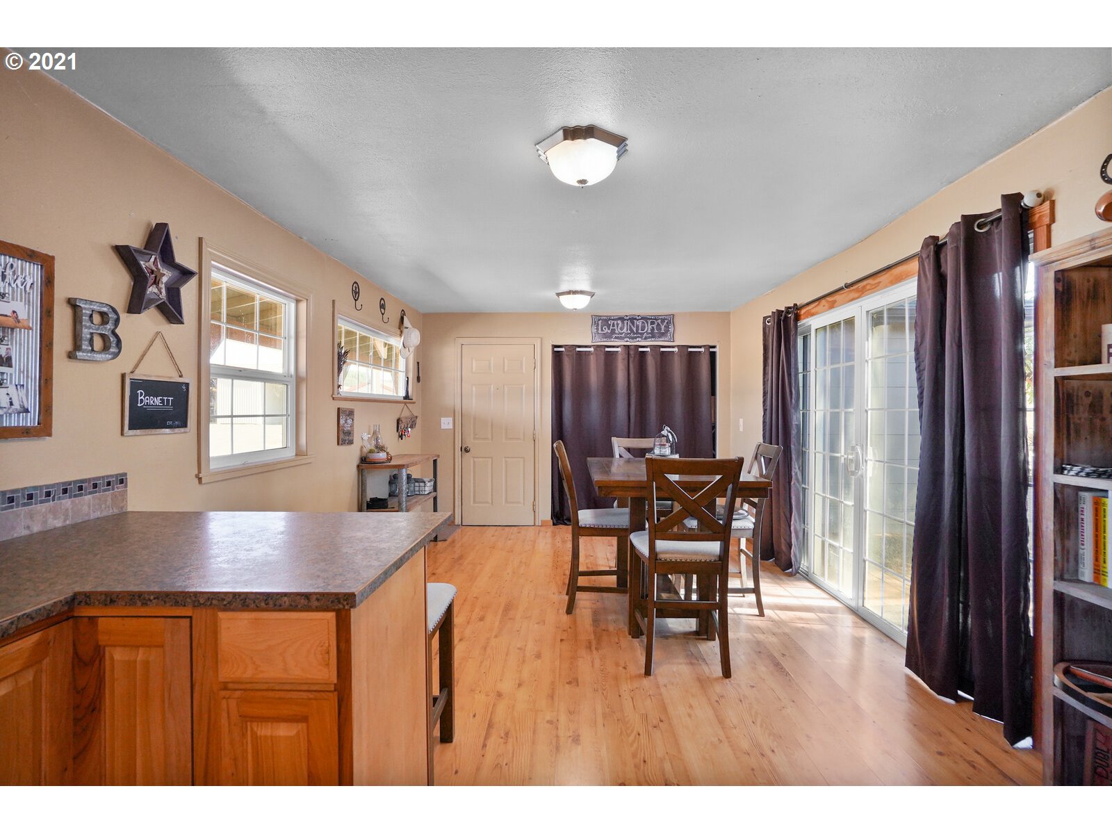 9310 Harmony Road Sheridan, OR 97378 - Photo 10 of 32 a kitchen with stainless steel appliances granite countertop a table chairs and a refrigerator