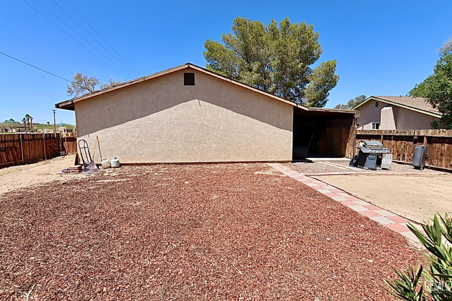 Undisclosed Address Ridgecrest, CA 93555 - Photo 3 of 8 a view of a house with a yard
