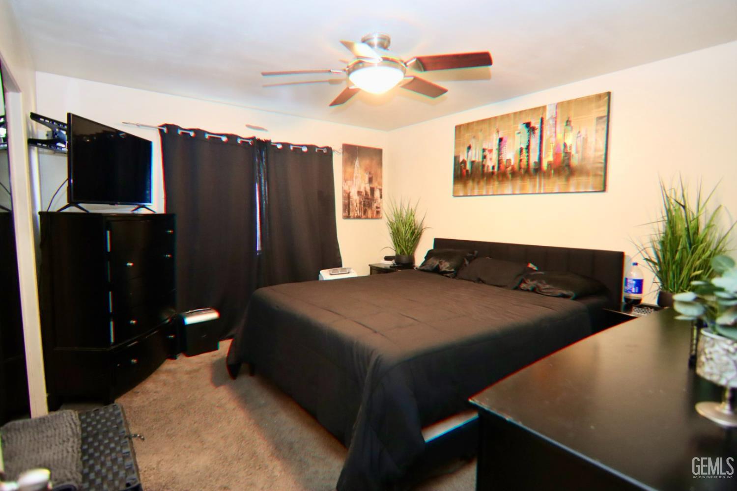 Undisclosed Address Ridgecrest, CA 93555 - Photo 8 of 8 a bedroom with a bed and a chandelier