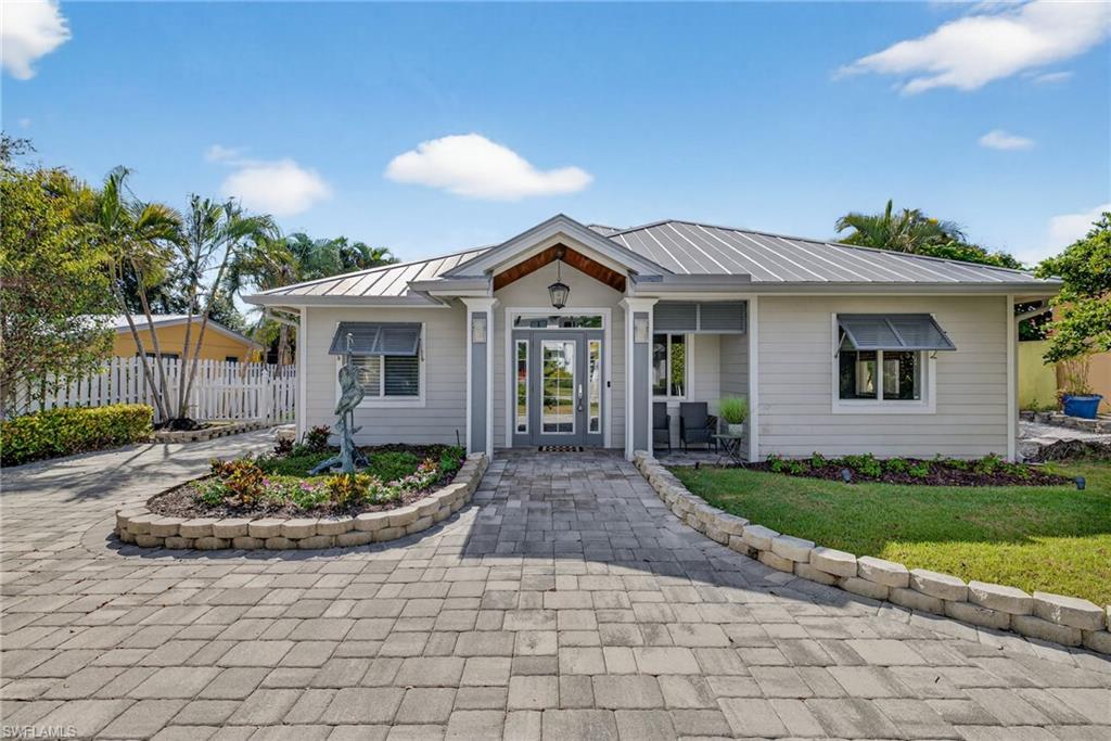 View of front of house with a metal roof