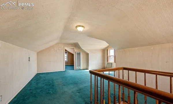 a view of entryway with a window and wooden floor