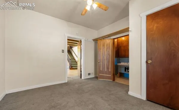 an empty room with windows and closet