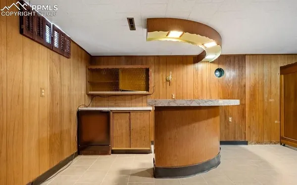 a view of kitchen with stainless steel appliances granite countertop cabinets and a wooden floor
