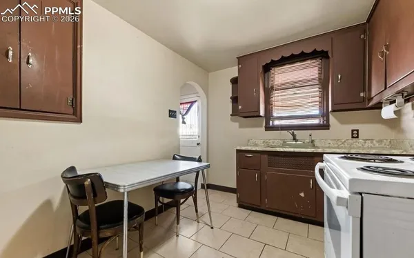 a kitchen with a stove top oven and refrigerator