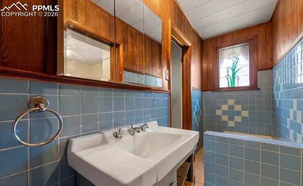 a bathroom with a sink a mirror and a window