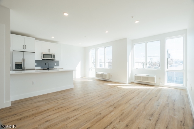 67 Dr Martin Luther King Jr Boulevard, Unit 204 Newark, NJ 07104 - Photo 1 of 27 a large kitchen with granite countertop a large counter top stainless steel appliances and cabinets