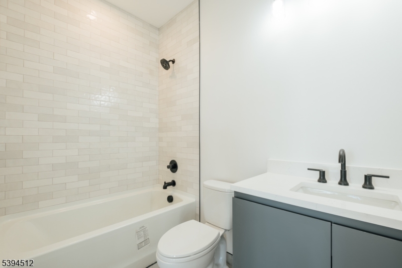 67 Dr Martin Luther King Jr Boulevard, Unit 204 Newark, NJ 07104 - Photo 11 of 27 a bathroom with a sink a toilet and shower