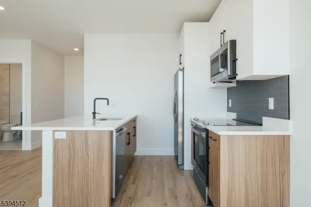 a kitchen with a stove top oven and sink