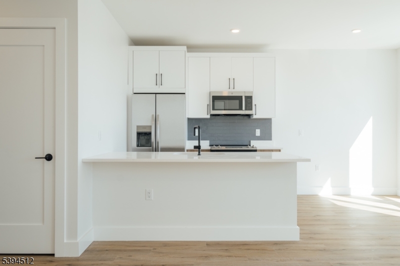 67 Dr Martin Luther King Jr Boulevard, Unit 204 Newark, NJ 07104 - Photo 7 of 27 a kitchen with kitchen island a sink appliances and cabinets
