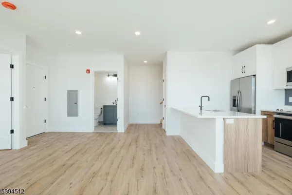 a view of a kitchen with wooden floor