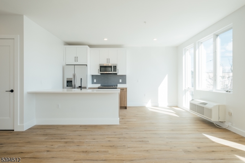 67 Dr Martin Luther King Jr Boulevard, Unit 204 Newark, NJ 07104 - Photo 10 of 27 a view of kitchen with wooden floor and electronic appliances