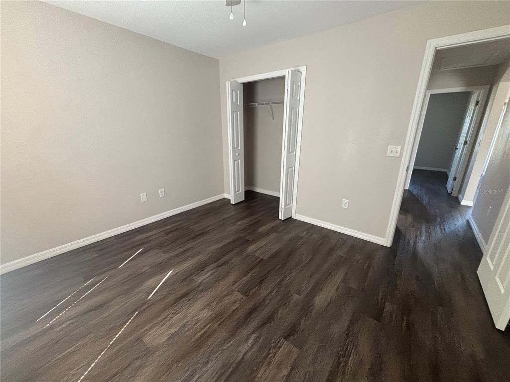 6561 Southwest 129th Loop Ocala, FL 34473 - Photo 11 of 21 a view of a room with wooden floor and staircase