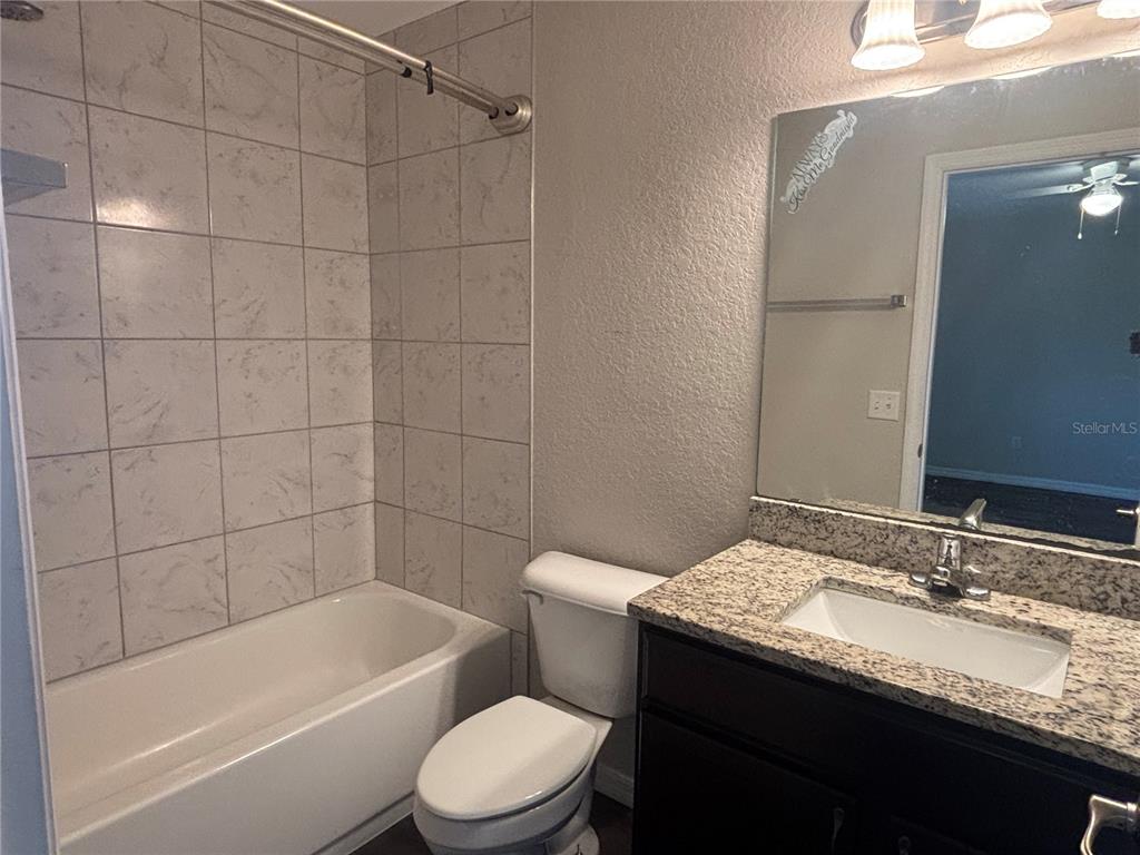 6561 Southwest 129th Loop Ocala, FL 34473 - Photo 17 of 21 a bathroom with a granite countertop sink toilet and shower