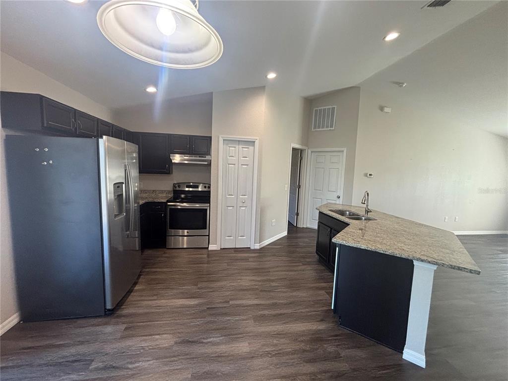 6561 Southwest 129th Loop Ocala, FL 34473 - Photo 4 of 21 a kitchen with stainless steel appliances granite countertop a refrigerator and a stove top oven
