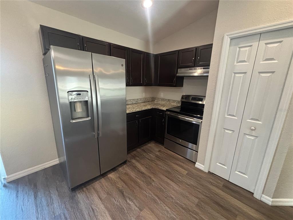 6561 Southwest 129th Loop Ocala, FL 34473 - Photo 6 of 21 a kitchen with stainless steel appliances granite countertop a refrigerator and a sink