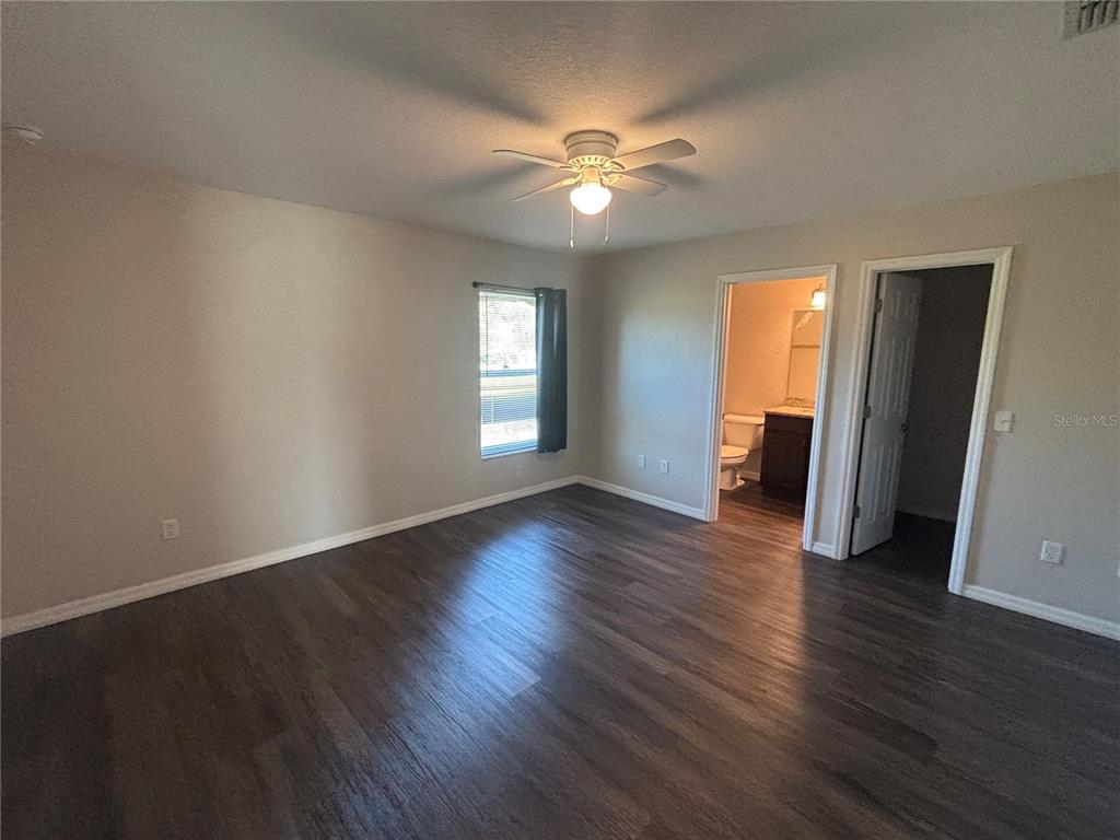 6561 Southwest 129th Loop Ocala, FL 34473 - Photo 8 of 21 a view of an empty room with wooden floor and a window