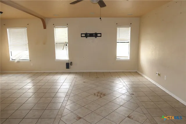 an empty room with windows and closet