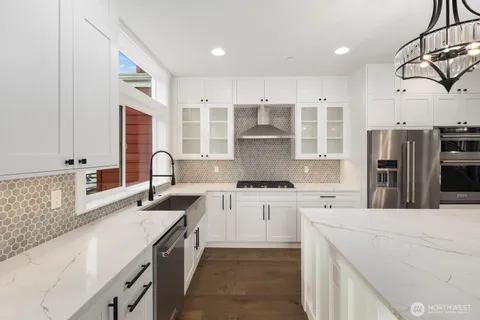 a view of a hallway with wooden floor and a fireplace