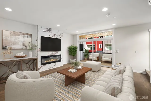 a view of a big room with wooden floor and windows