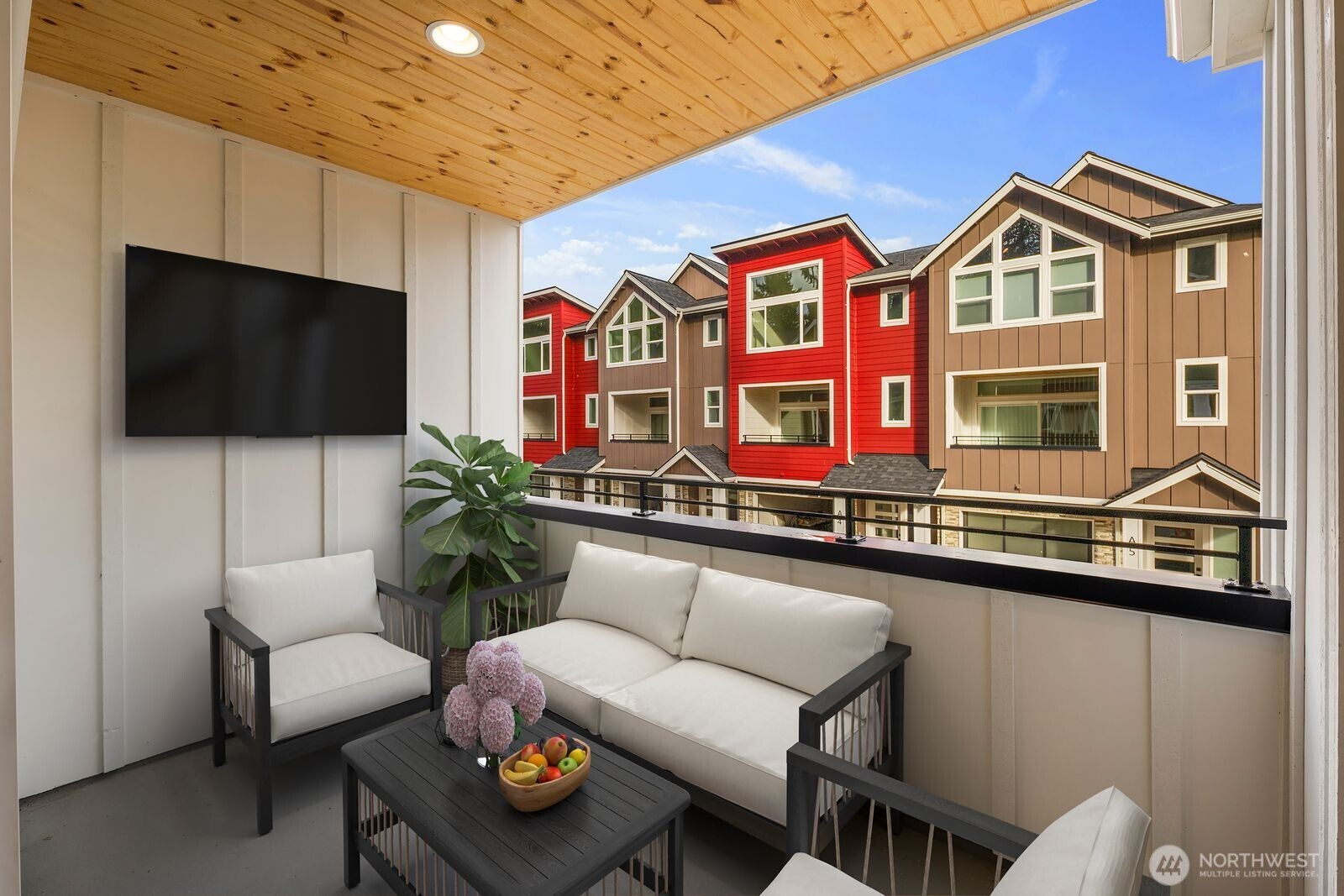 19722 Filbert Drive, Unit 10 Bothell, WA 98012 - Photo 23 of 33 a living room with furniture a flat screen tv and kitchen view