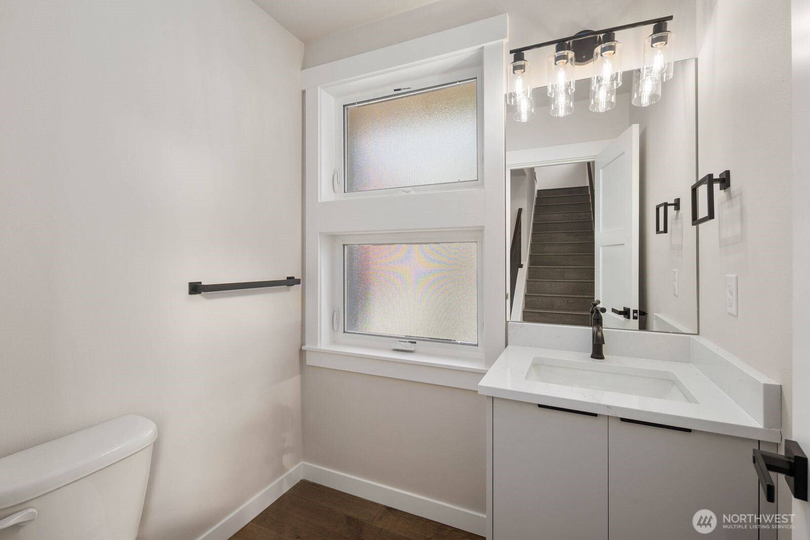 19722 Filbert Drive, Unit 10 Bothell, WA 98012 - Photo 24 of 33 a bathroom with a sink and mirror with toilet