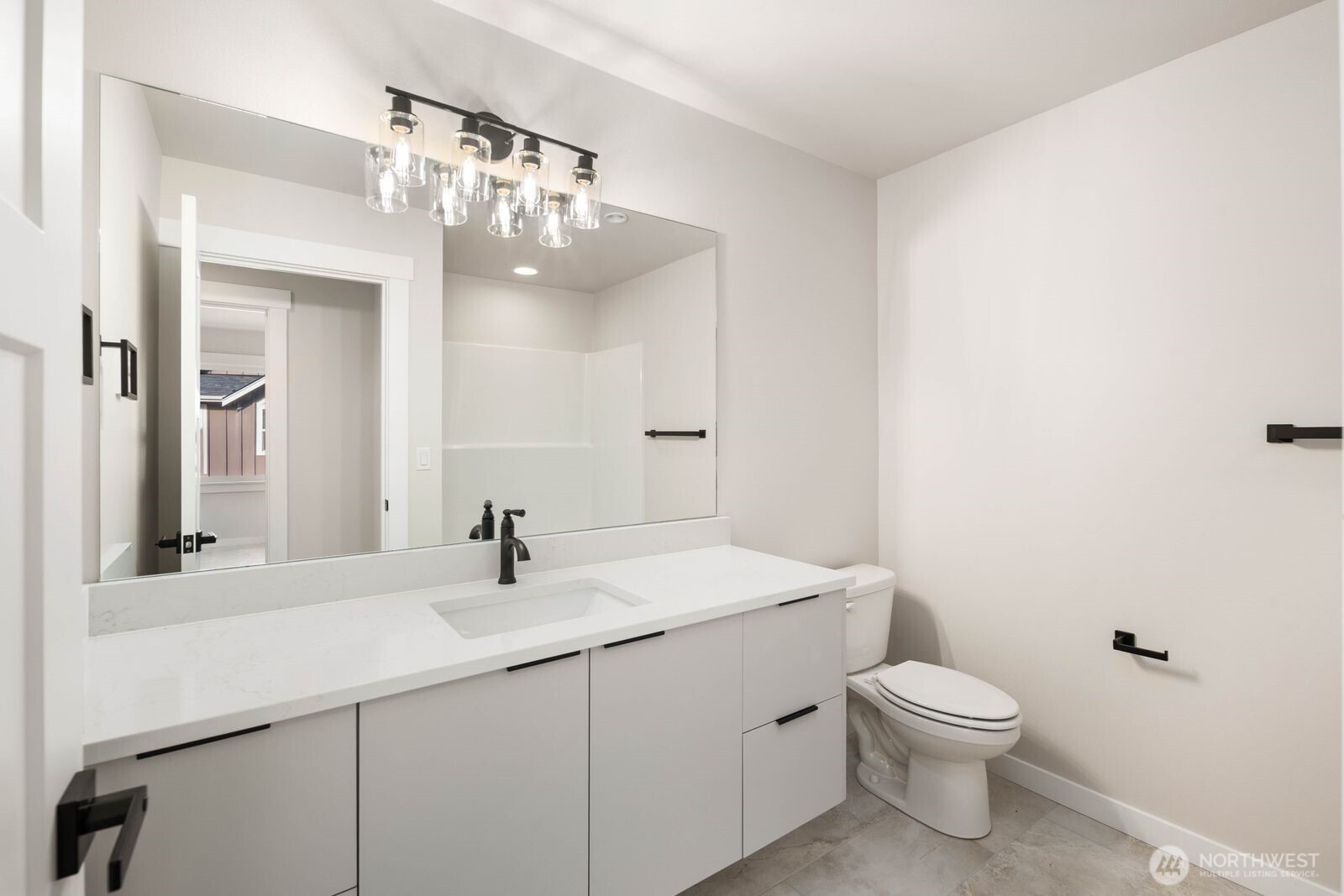 19722 Filbert Drive, Unit 10 Bothell, WA 98012 - Photo 27 of 33 a bathroom with a sink a mirror and a toilet
