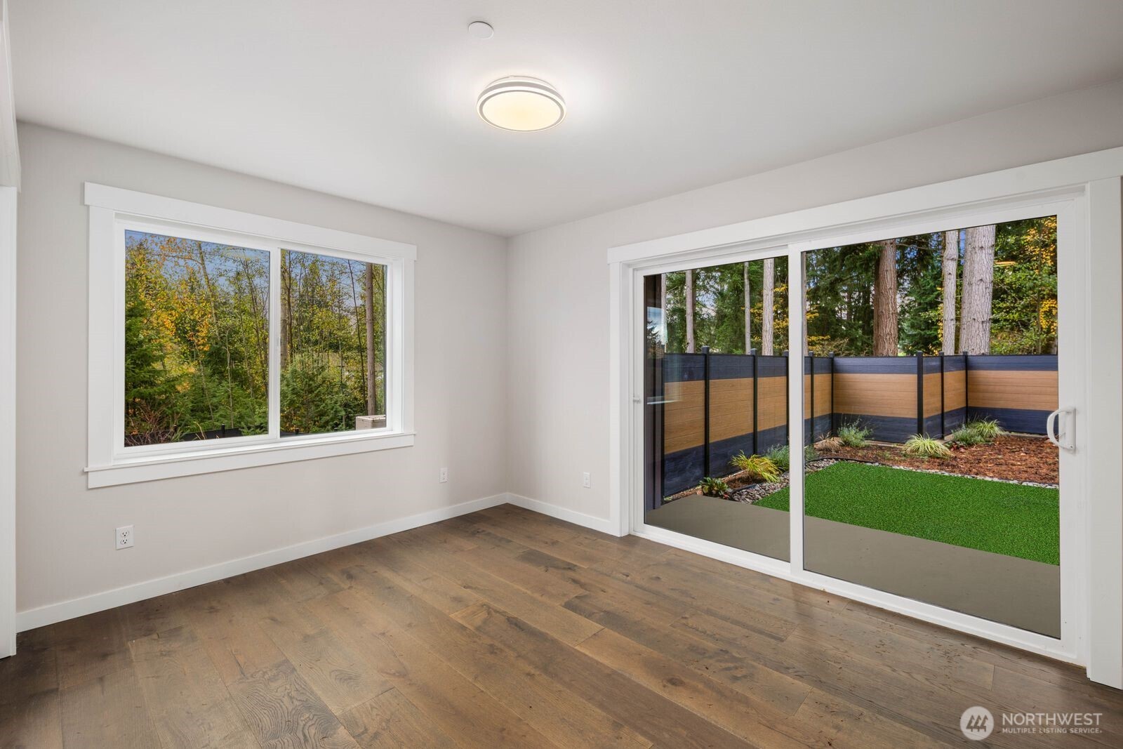 19722 Filbert Drive, Unit 10 Bothell, WA 98012 - Photo 6 of 33 a view of an empty room with wooden floor and a window