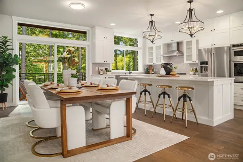 a kitchen with stainless steel appliances granite countertop a sink a stove and a refrigerator