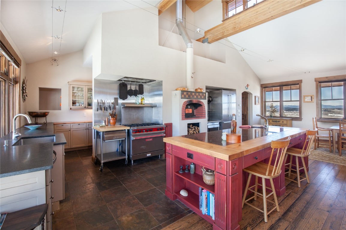 742 Lumberjack Road Fairplay, CO 80440 - Photo 11 of 35 a room with stainless steel appliances kitchen island granite countertop a table chairs and a refrigerator