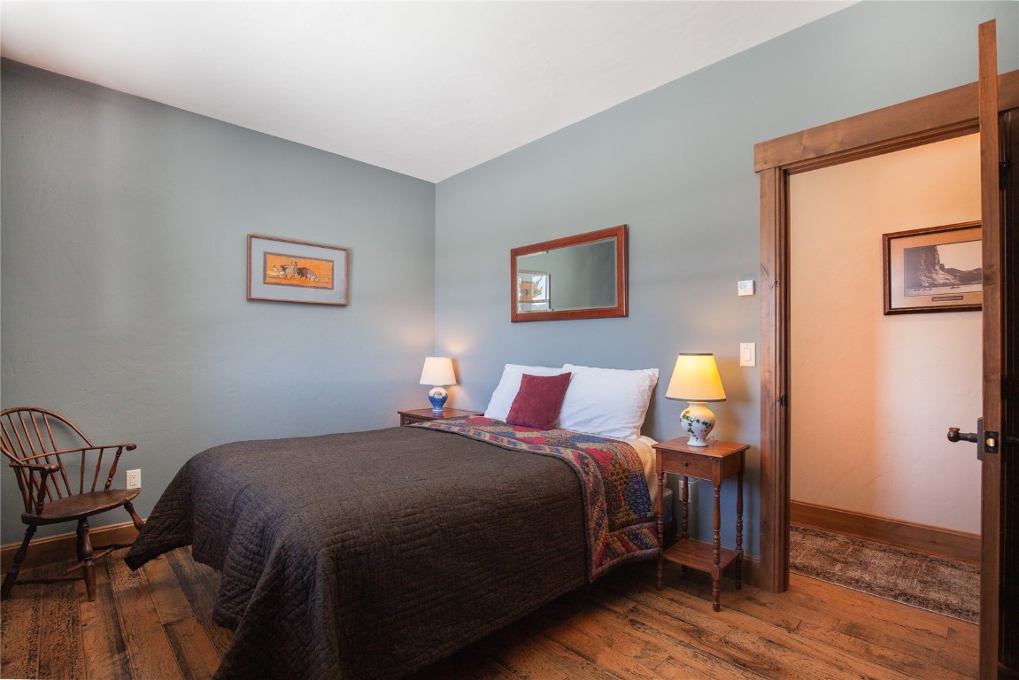 742 Lumberjack Road Fairplay, CO 80440 - Photo 22 of 35 a bedroom with a bed and wooden floor