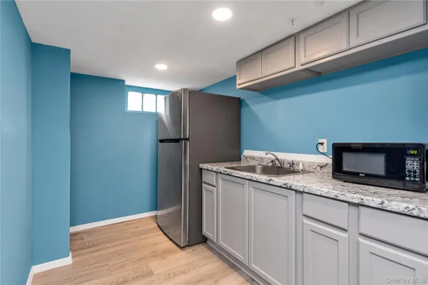 a kitchen with stainless steel appliances granite countertop cabinets and refrigerator