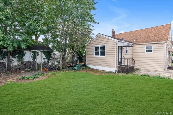 a view of a house with a yard and sitting area