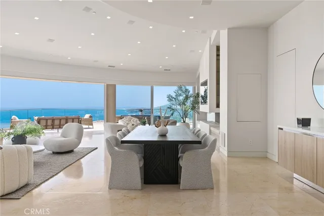 a large white kitchen with a stove and a large window