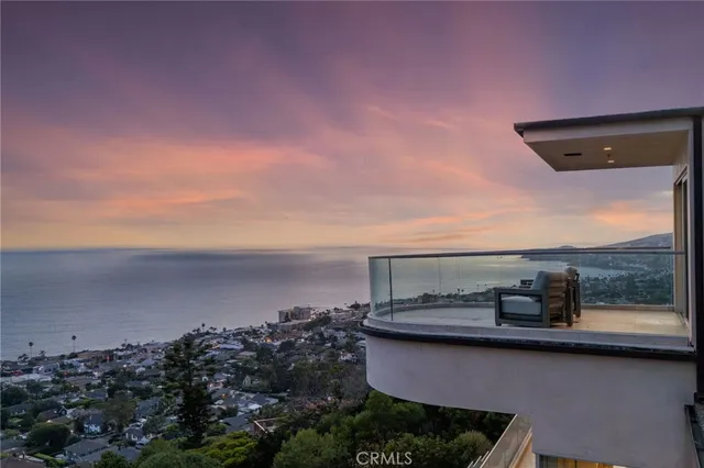an aerial view of a city with lots of residential buildings and mountain view in back