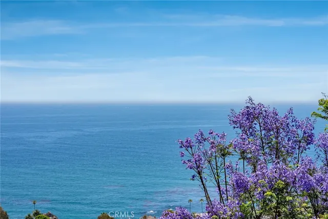 an aerial view of multiple houses with a yard