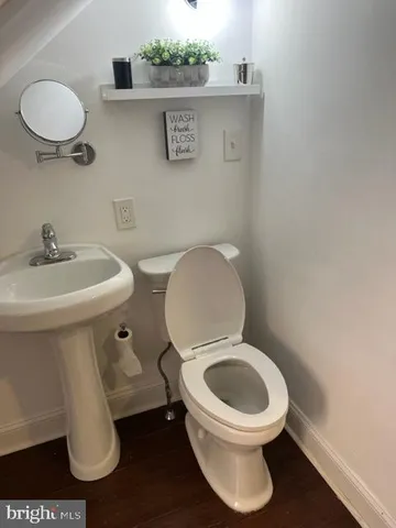 a white toilet sitting next to a bathroom sink