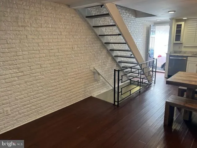a view of entryway with wooden floor and stairs