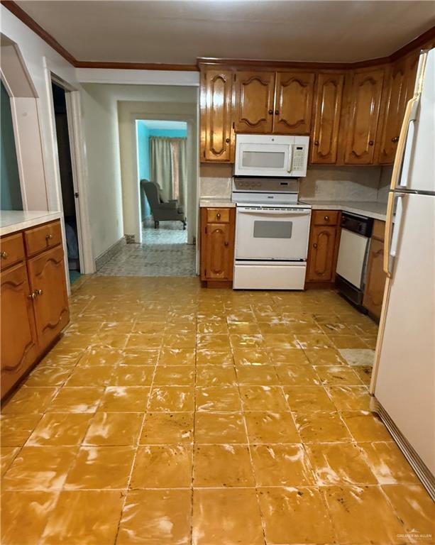 120 East Adams Street Mission, TX 78573 - Photo 3 of 4 a kitchen with granite countertop a stove a sink and a refrigerator