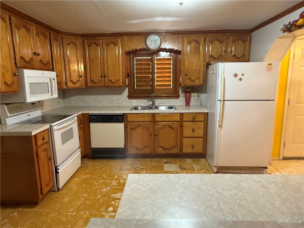 120 East Adams Street Mission, TX 78573 - Photo 4 of 4 a kitchen with stainless steel appliances granite countertop a refrigerator a stove a sink and a refrigerator
